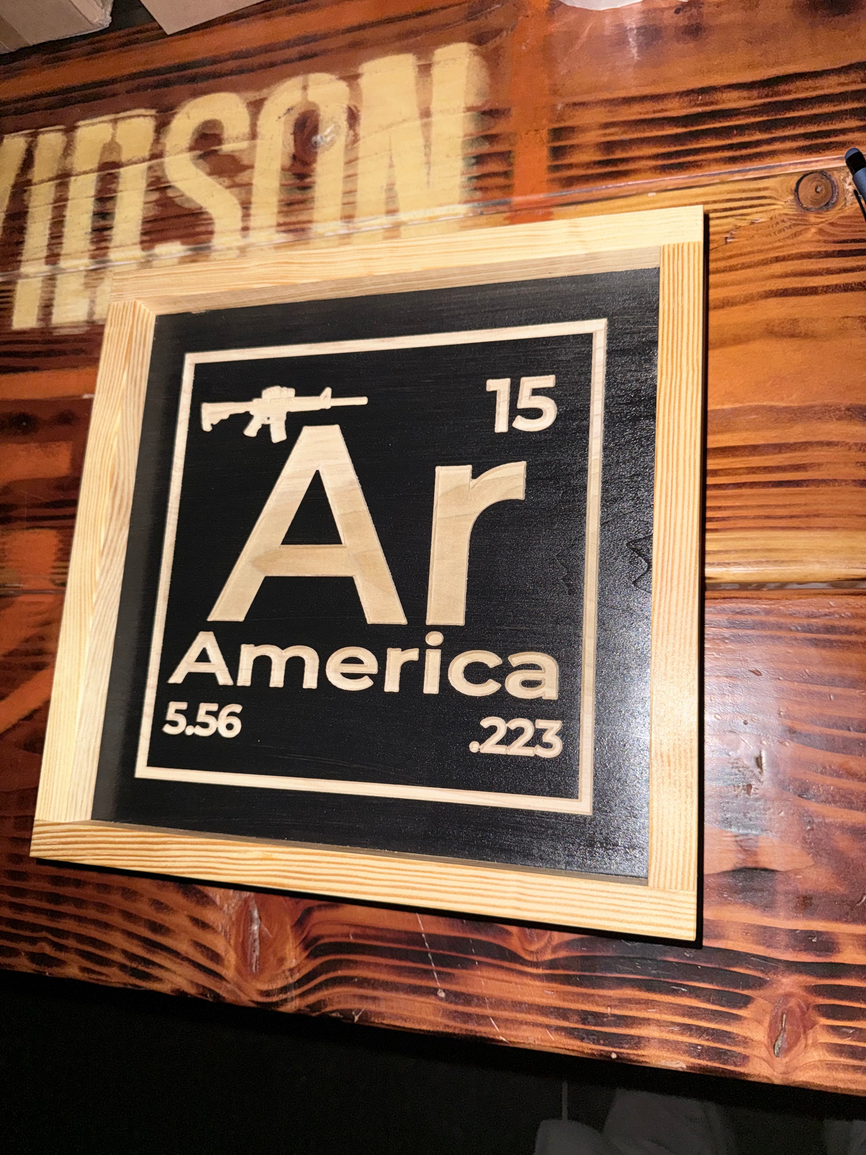 Decorative sign with 'AR America' design on a wooden background